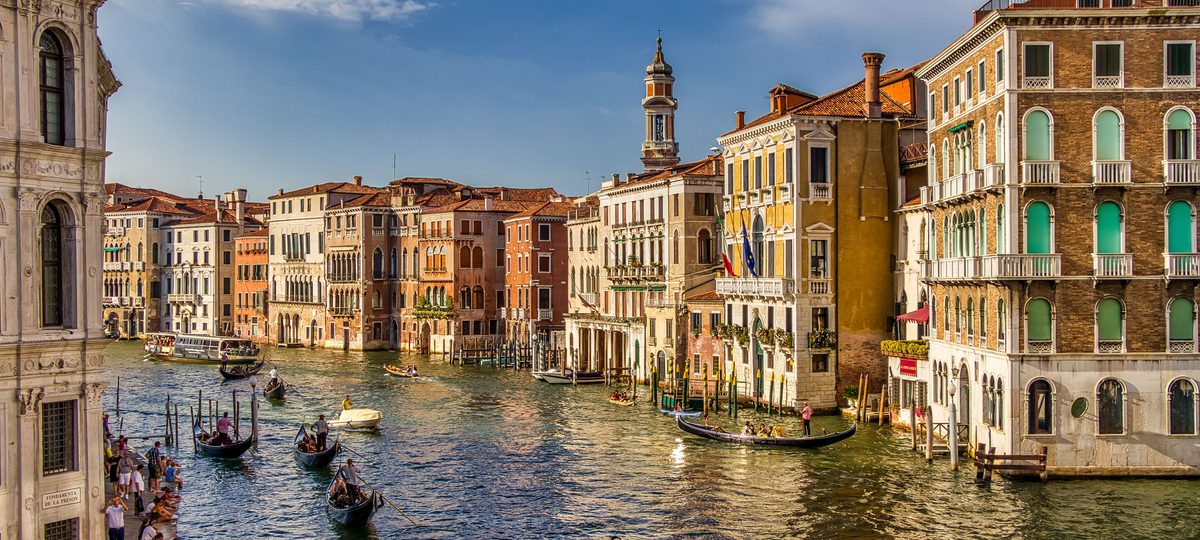 Gondolas on the Grand Canal between the painted palazzi of Venice.